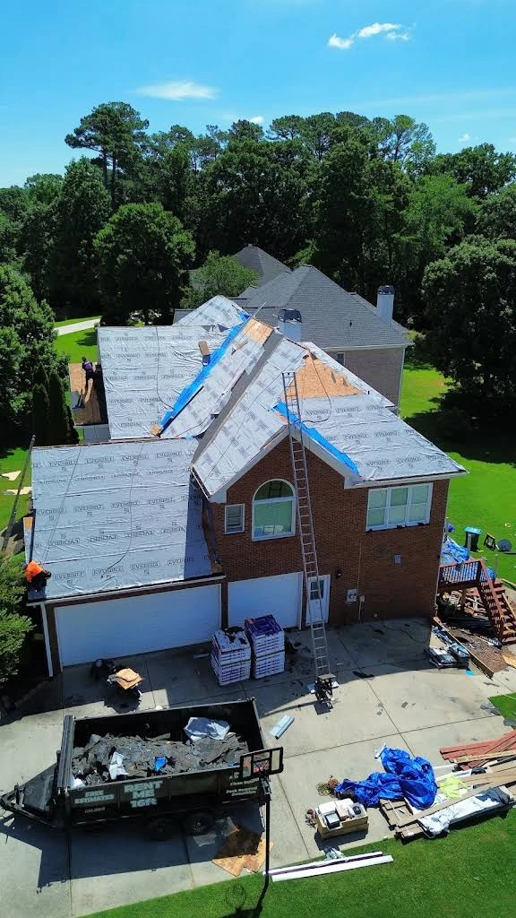 Residential roof installation with underlayment visible